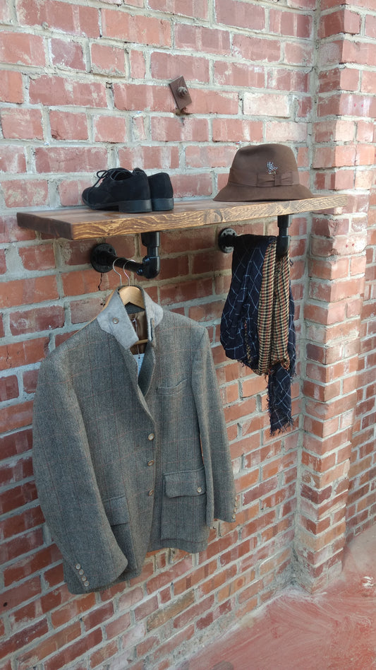 a rustic industrial shelf made with reclaimed scaffold board and powder coated black pipe wall brackets. entryway storage. hallway storage. coat stand. open wardrobe. shop display
