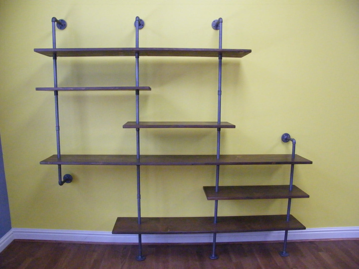 a floor standing bookcase shelving unit with asymmetric shelving in a walnut style finish - an asymmetric bookcase media unit tv unit, modern furniture, contemporary design custom bookcase