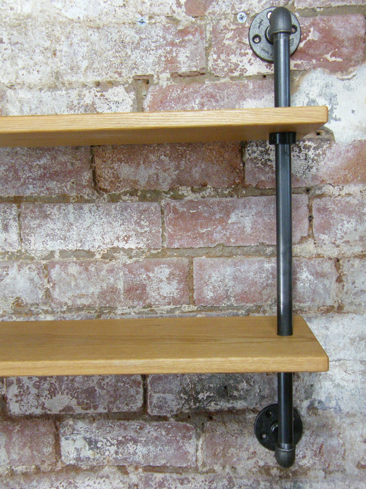 a contemporary wall hanging shelving unit made from industrial gas pipe struts and solid european oak. Perfect for kitchen shelves or living room shelves.