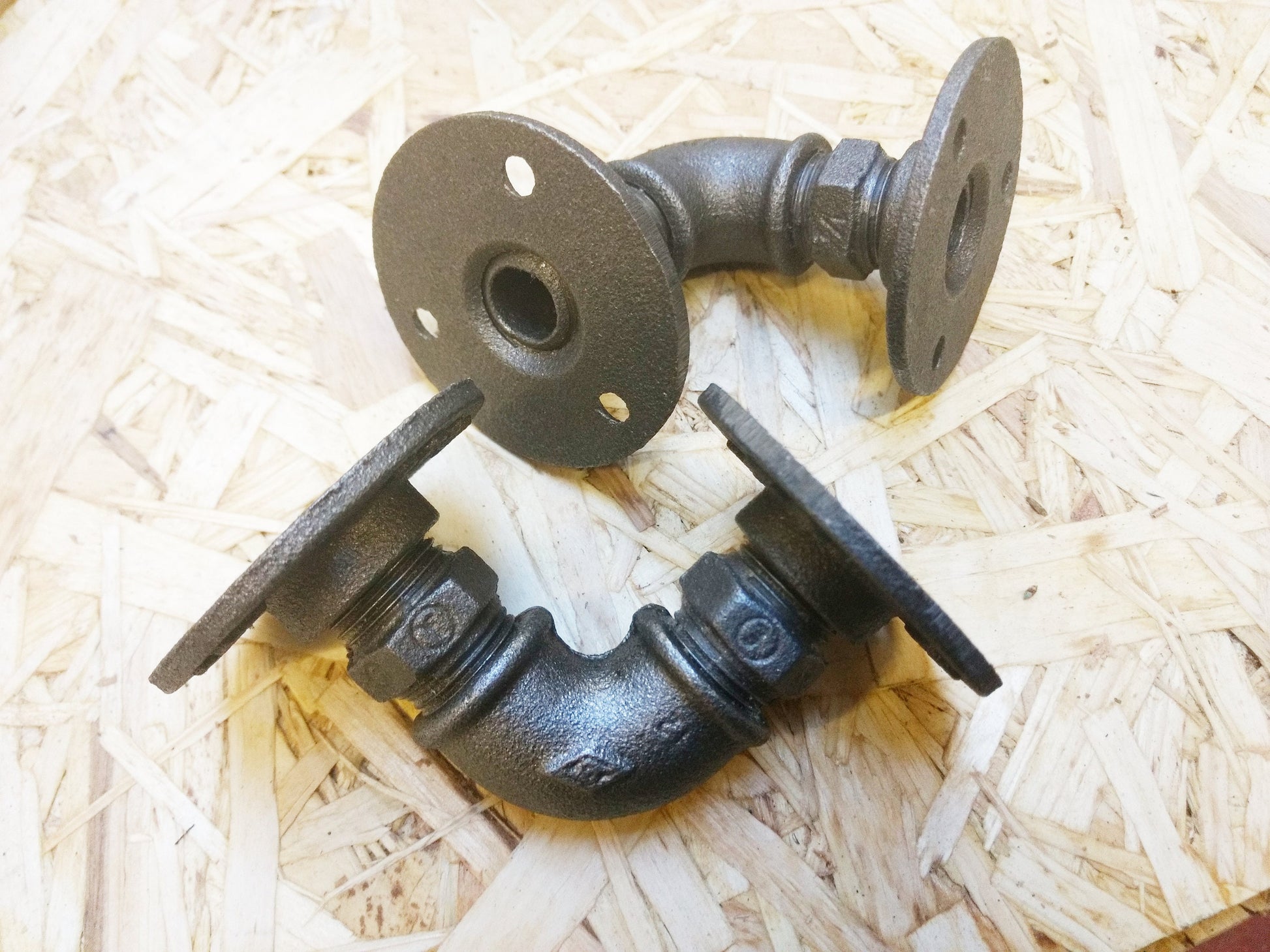 A pair of industrial gas pipe shelf brackets