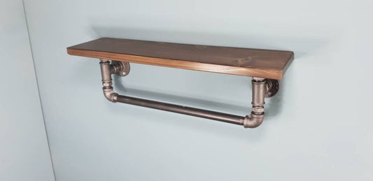 a single shelf with a walnut finish top, malleable iron gas pipe fittings and a towel rail coming out of the bottom of the shelf