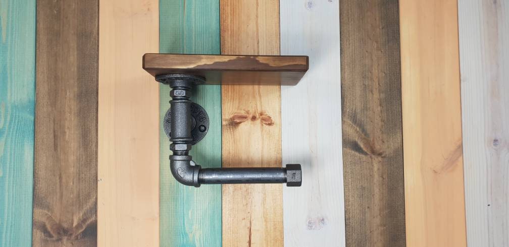 a set : a single towel rail on a walnut finish backing plate and a toilet roll holder with a walnut finish mini shelf above it