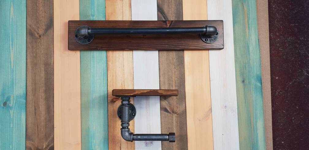 a set : a single towel rail on a walnut finish backing plate and a toilet roll holder with a walnut finish mini shelf above it