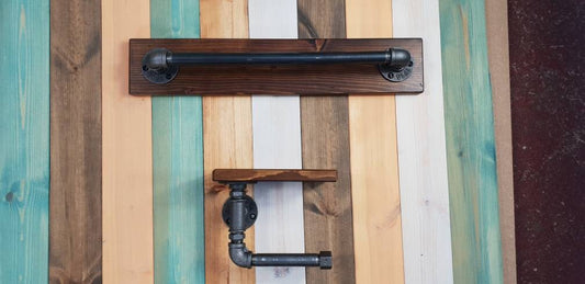 a set : a single towel rail on a walnut finish backing plate and a toilet roll holder with a walnut finish mini shelf above it