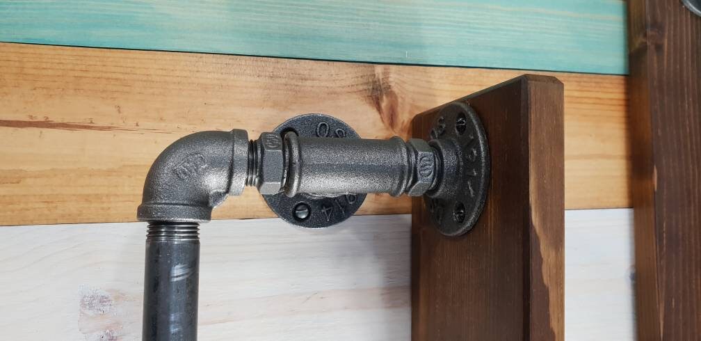 a set : a single towel rail on a walnut finish backing plate and a toilet roll holder with a walnut finish mini shelf above it