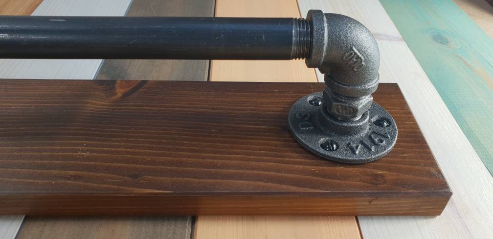 a set : a single towel rail on a walnut finish backing plate and a toilet roll holder with a walnut finish mini shelf above it