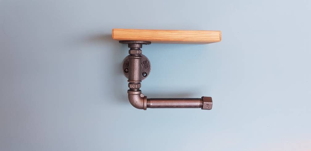 A set of industrial style bathroom fixtures. A gas pipe toilet roll holder with solid oak top and an industrial gas pipe towel rail on a solid oak back plate. contemporary, minimalist, industrial modern bathroom furniture fittings. toilet roll holder and towel rail