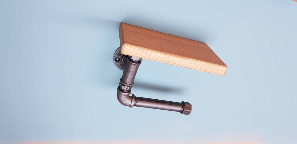 A set of industrial style bathroom fixtures. A gas pipe toilet roll holder with solid oak top and an industrial gas pipe towel rail on a solid oak back plate. contemporary, minimalist, industrial modern bathroom furniture fittings. toilet roll holder and towel rail