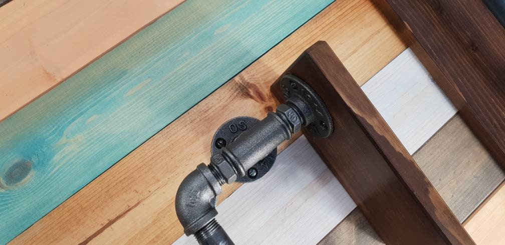 a set : a single towel rail on a walnut finish backing plate and a toilet roll holder with a walnut finish mini shelf above it