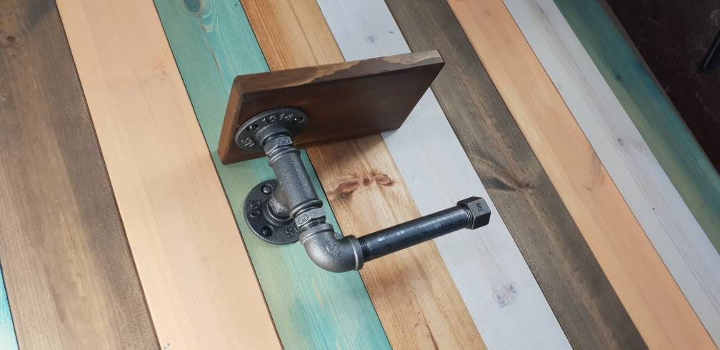 a set : a single towel rail on a walnut finish backing plate and a toilet roll holder with a walnut finish mini shelf above it