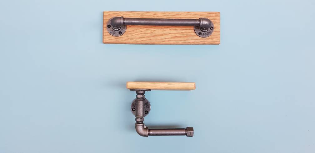 A set of industrial style bathroom fixtures. A gas pipe toilet roll holder with solid oak top and an industrial gas pipe towel rail on a solid oak back plate. contemporary, minimalist, industrial modern bathroom furniture fittings. toilet roll holder and towel rail