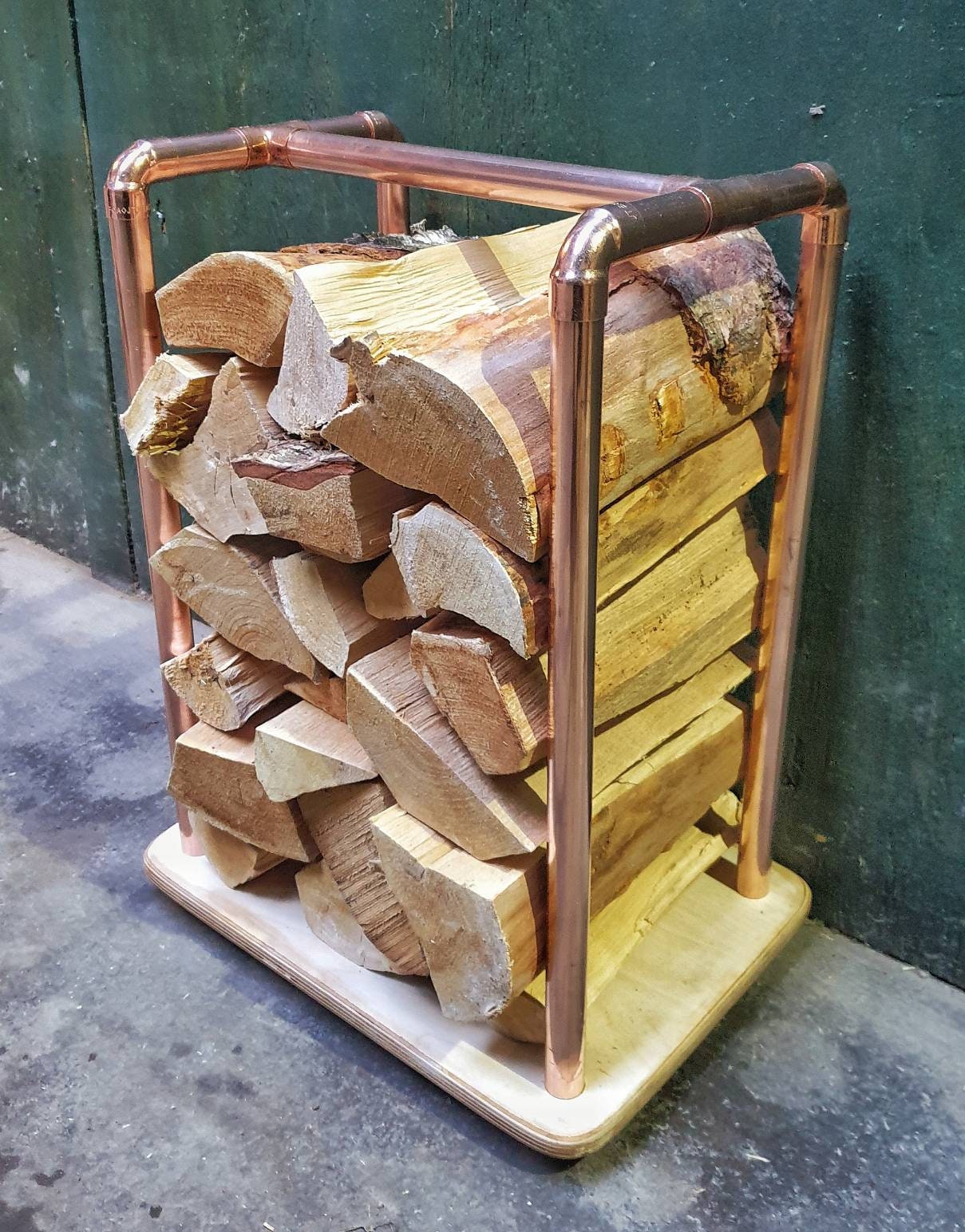 rectangular copper pipe log store with birch plywood base, holds 10kgs of chopped wood. 38 x 28 x 70cm