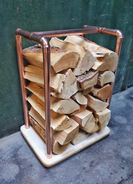 rectangular copper pipe log store with birch plywood base, holds 10kgs of chopped wood. 38 x 28 x 70cm