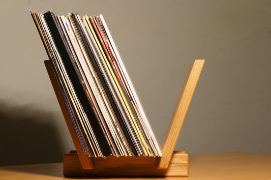 A solid oak LP record holder record storage. 2 struts and 2 panels allow storage and flip through to view records , then select them, then play the tunes. holds up to 70 records
